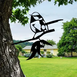 Metal bird silhouette garden stake detail, outdoor tree branch decor, durable black metal art.