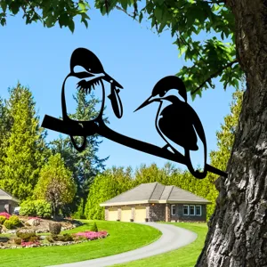 Metal bird tree silhouette decor detail, outdoor garden art ornament close-up view.