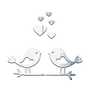 Close-up detail of silver acrylic mirror wall sticker featuring cute birds on branch and hearts.