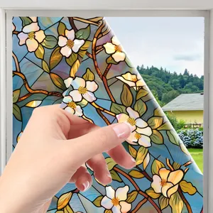 Close-up detail showing the floral stained glass window film peeling off easily by hand.