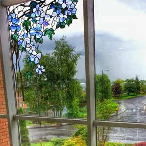 Decorative stained glass window film with blue floral pattern, static cling privacy sticker.
