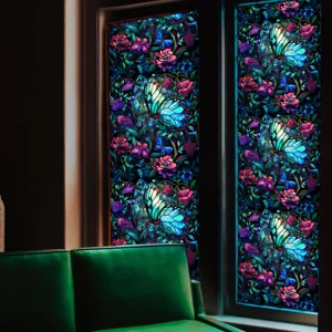 Stained glass window film detail showcasing glowing butterfly and floral patterns for home decor.