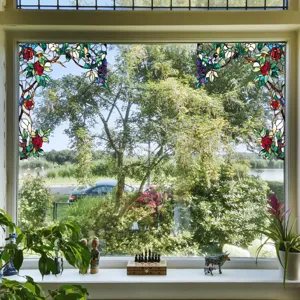 Decorative stained glass window film with floral rose pattern for privacy and home decor.