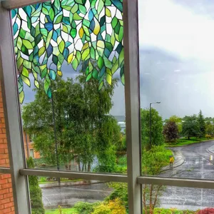 Stained glass window film with green leaf design, static cling privacy decorative film.