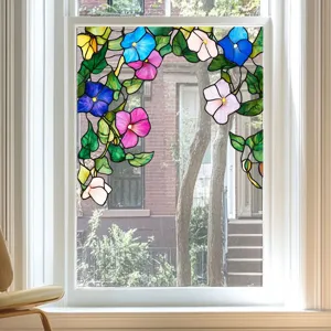 Stained glass window film detail showing colorful floral and green leaf privacy sticker design.