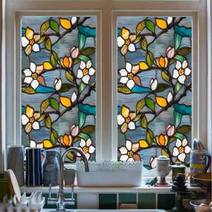 Detailed view of stained glass window film with colorful floral patterns for home decor.