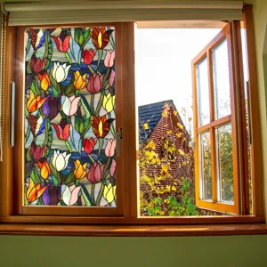 Stained glass window film detail showing colorful tulip floral pattern installed on glass.