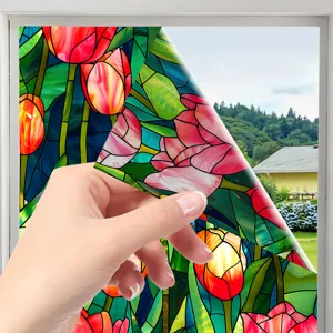 Detail view of colorful stained glass tulip window sticker showing privacy film texture and effect.