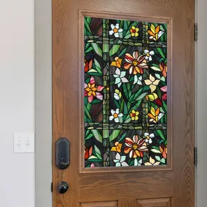 Detail view of stained glass window film with vibrant floral pattern on door glass.