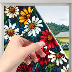 Close-up detail of colorful stained glass window film, daisy floral pattern peeling demonstration.