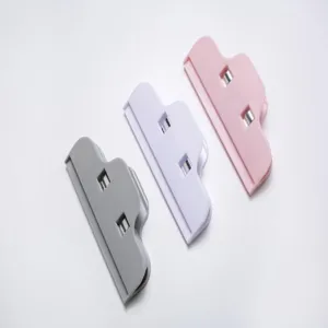 Plastic food sealing clip detail shot, snack preservation bag clamp with spring design.