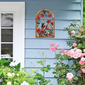 Closeup of arch wooden metal wall hanging with floral bird decor on blue panel wall.