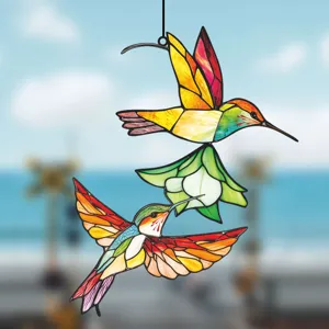 Detailed shot of double sided metal stained glass hummingbird window hanging decoration art.