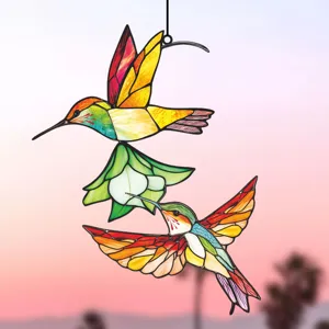Stained glass hummingbird hanging ornament detail view showing vibrant colorful birds and flower design.