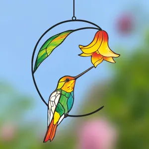 Close-up detail of the metal iron hummingbird and flower stained glass window hanging decoration.