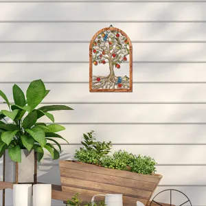 Detailed view of the wooden frame and metal tree wall art with birds and apples for decor.