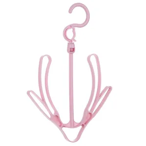 Support de sechage de chaussures en plastique rose, crochet pour balcon et buanderie.