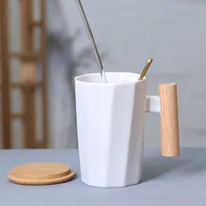 White ceramic coffee mug with wooden handle, lid and spoon for daily office home use.