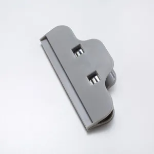 Grey plastic food sealing clip for snack bags and kitchen storage, main product top view.
