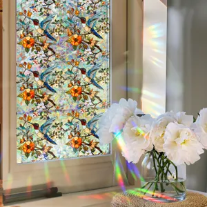 Detailed view of colorful stained glass window film featuring hummingbird and floral patterns.