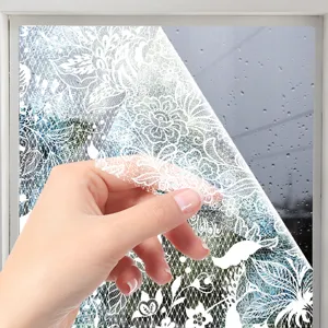 Close-up view of a white lace window glass sticker being peeled off, modern pattern detail.