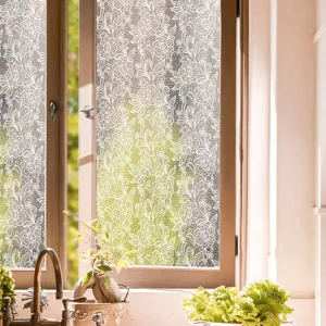 Detailed view of white floral lace static window film, offering privacy and elegant home decor.