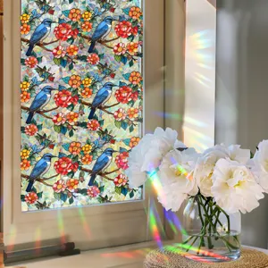 Close-up detail of colorful stained glass window film featuring blue bird and flower pattern.
