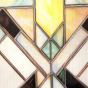 Close-up detail of 3D embossed stained glass window sticker with geometric art deco pattern.
