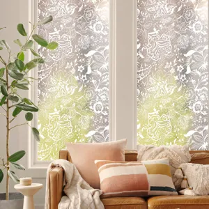 Decorative lace window film lifestyle detail in living room with cozy sofa and plants background.