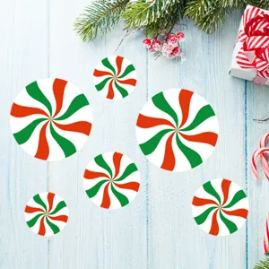 Christmas peppermint tile stickers showing red green swirl patterns on wooden background.