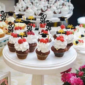 Closeup of graduation cupcake toppers with glitter paper 2024 and cap design on cupcakes.