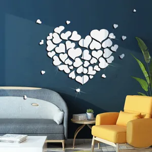 Detailed view of heart-shaped acrylic mirror wall sticker in modern living room scene.