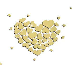 Close-up of golden acrylic mirror heart stickers detail, shiny reflective wall decor texture.