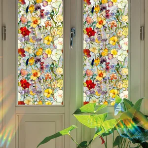 Close-up view of colorful floral stained glass window film detail with sunny plant scene.