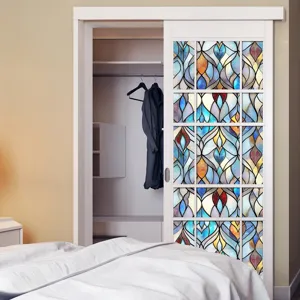 Detail view of colorful stained glass window film applied on sliding door, abstract geometric pattern.