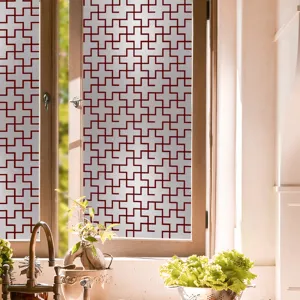 Film de vitrage décoratif avec motif géométrique rouge pour protection solaire intimité.