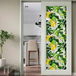 Film pour vitre décoratif avec motif de feuilles de monstera colorées pour décoration intérieure.