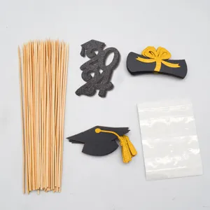 Graduation cake topper DIY set with wooden sticks and glitter graduation cap cards for party decoration.
