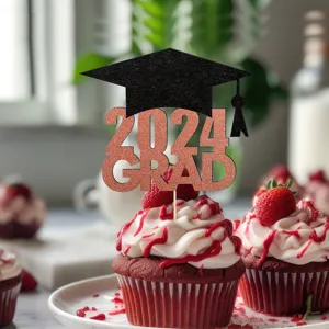 Close-up of glitter 2024 graduation cupcake topper with black cap on red velvet dessert.