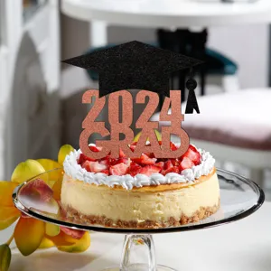 Close-up detail shot of a graduation cake topper with 2024 grad text and cap on a cake.