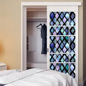 Close-up of 3D stained glass window film with geometric diamond pattern for home decor.