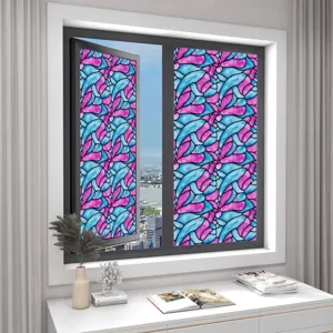 Close-up view of the colorful stained glass window film applied on a glass window in room.