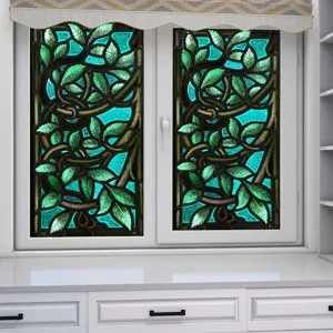 Stained glass window film detail showing vibrant botanical green leaf pattern on turquoise glass.