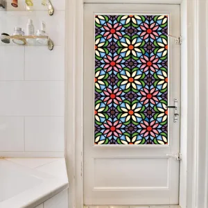 Stained glass window film detail showing colorful floral pattern applied on a white door in home decor.