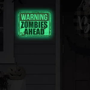 Detail shot of the Halloween luminous zombie warning sign glowing green in dark background.