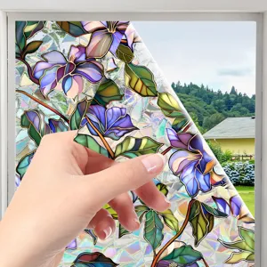 Stained glass window film detail showing vibrant purple floral pattern and static cling backing.