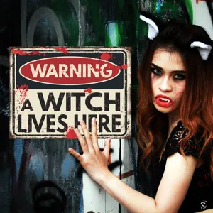 Detailed view of Halloween warning witch metal sign wall decor, spooky theme party display.
