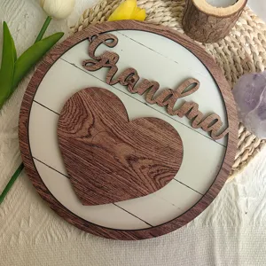 Wooden table plaque detail view showing engraved Grandma text and heart puzzle design.