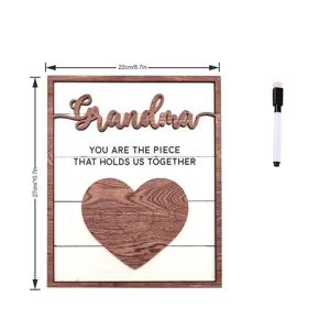 Detailed view of the wooden grandma plaque featuring heart puzzle design and accompanying marker.