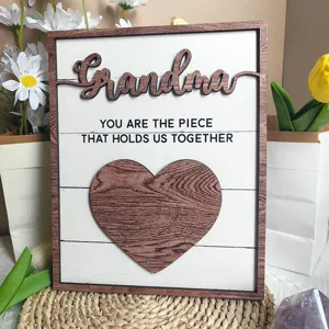 Close-up detail shot of wooden Mother Day gift plaque featuring Grandma puzzle heart design.